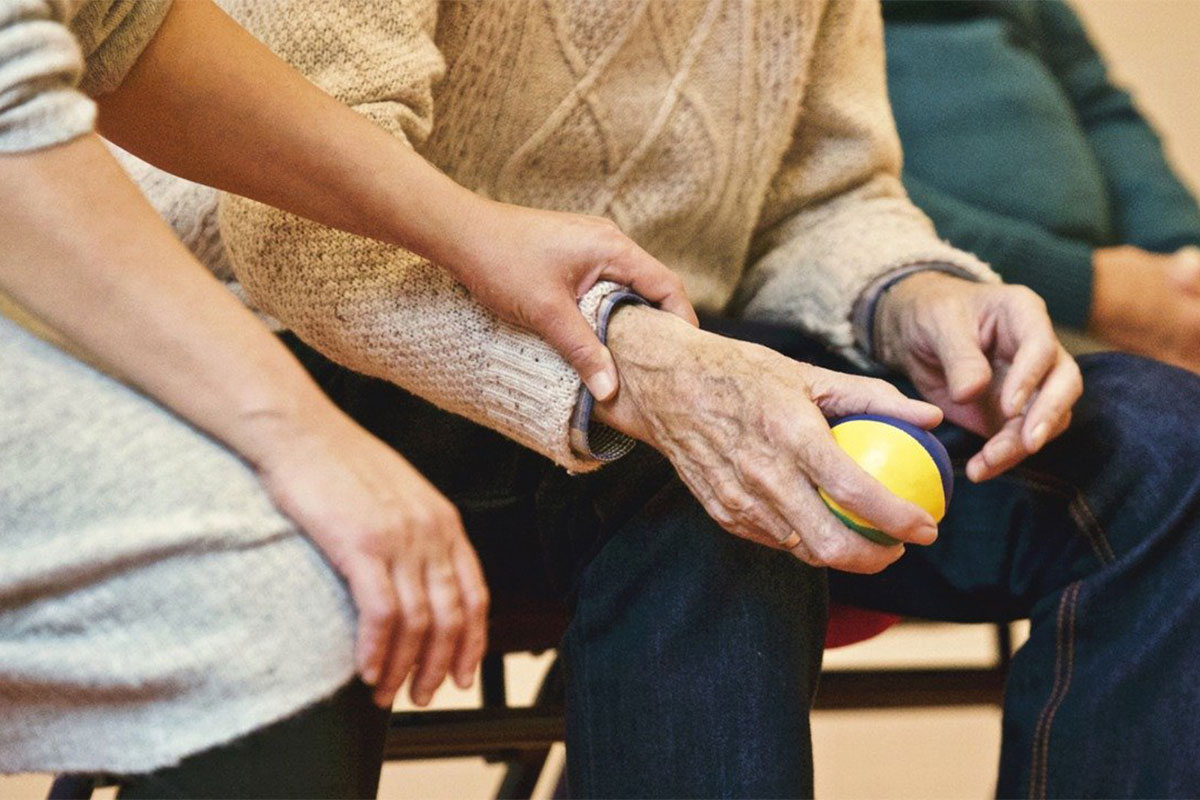 woman comforting elderly man